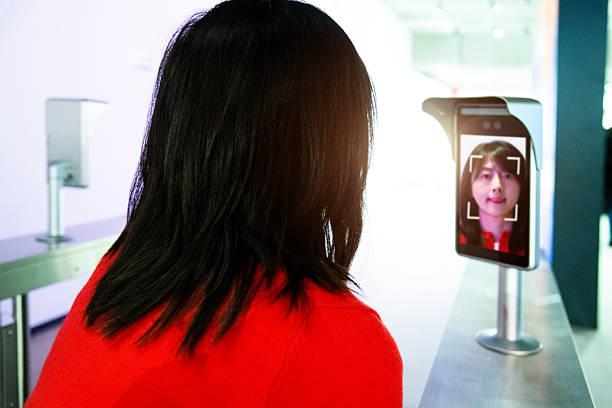 istock Young asian woman using face scanner to unlock the door 2210402839
