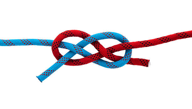 Closeup of the male hands making a bowline nautical knot