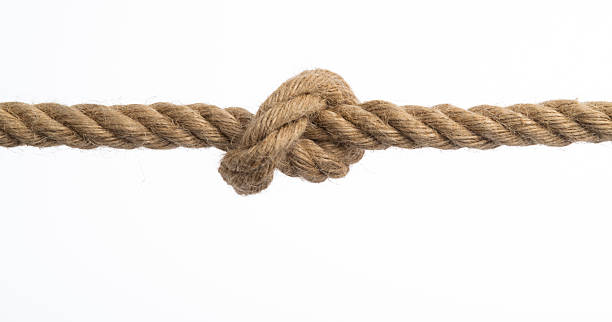 istock Overhand knot tied on brown hemp rope 2210402940