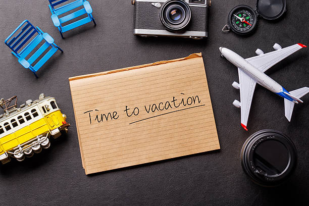 istock Creative flat lay of a travel-themed desk with notepad for plans 2210407296