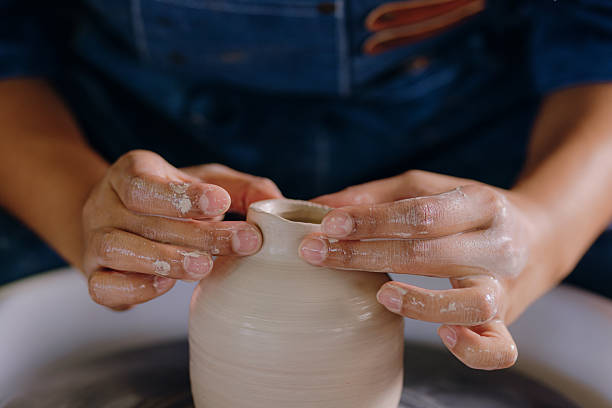 istock Latina artist shaping ceramic piece with her hands 2210410655