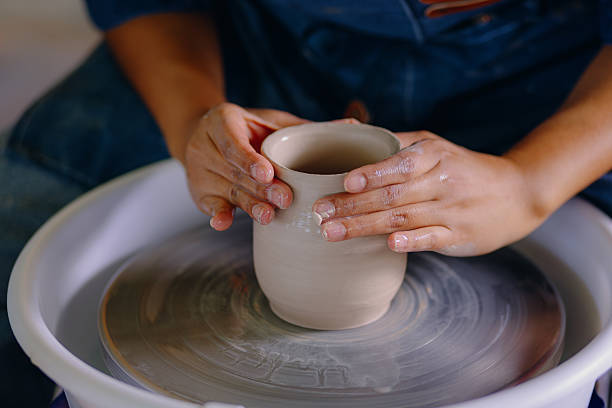 istock Latina artist shaping ceramic piece with her hands 2210410658