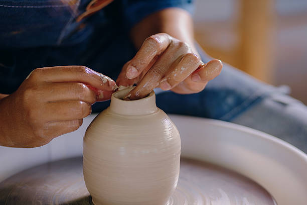 istock Latina artist shaping ceramic piece with her hands 2210410889
