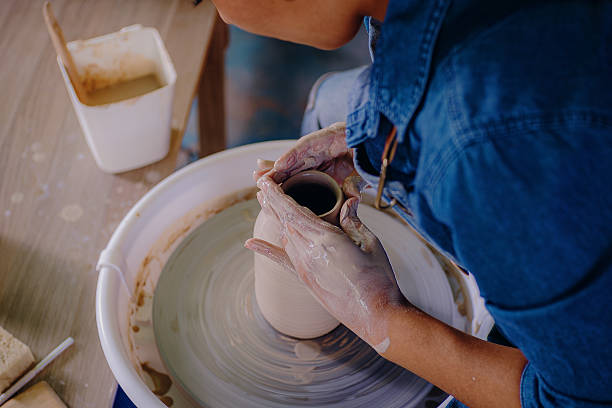 istock Latina artist shaping ceramic piece with her hands 2210411413