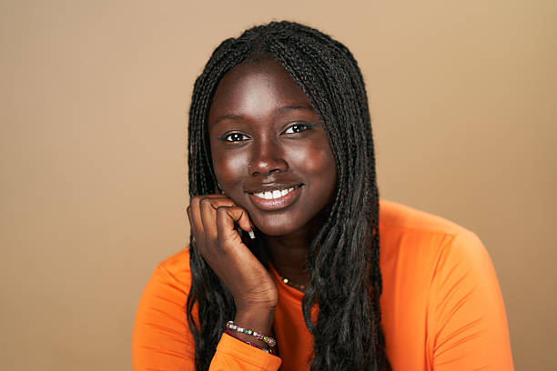 istock Young black woman with braids smiling at the camera 2210411633