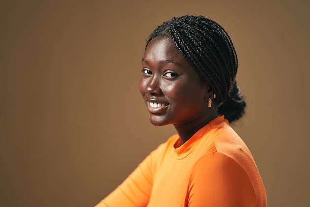 istock Young black woman with braids smiling at the camera 2210411651