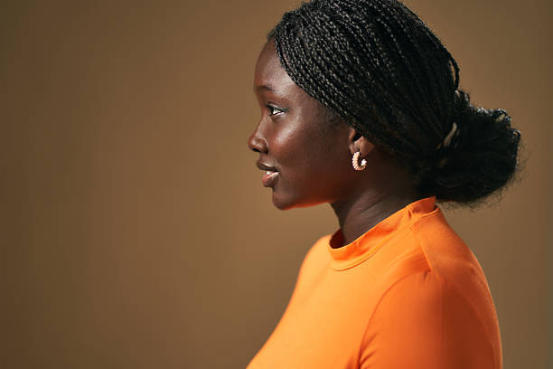 istock Young black woman with braids smiling in profile 2210411660