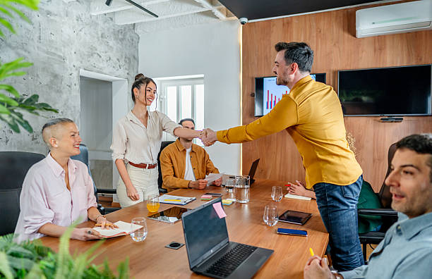 istock Young business people shaking hands 2210412421