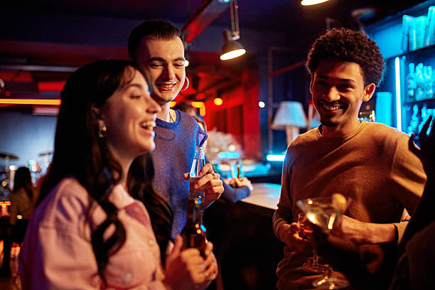 istock Relaxed friends enjoying drinks and leisure at nightclub 2210412921