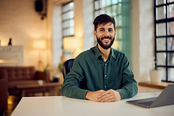 istock Smiling Man in Modern Office with a Casual and Welcoming Atmosphere 2210413300
