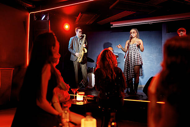 istock Black chanteuse singing with jazz band at nightclub 2210415866