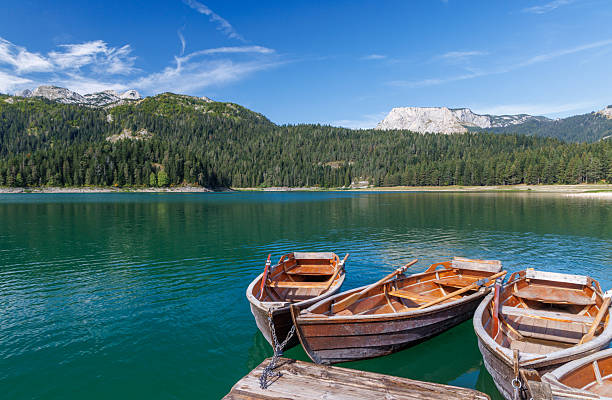 istock Scenic lake view with small boats gently floating 2210415975