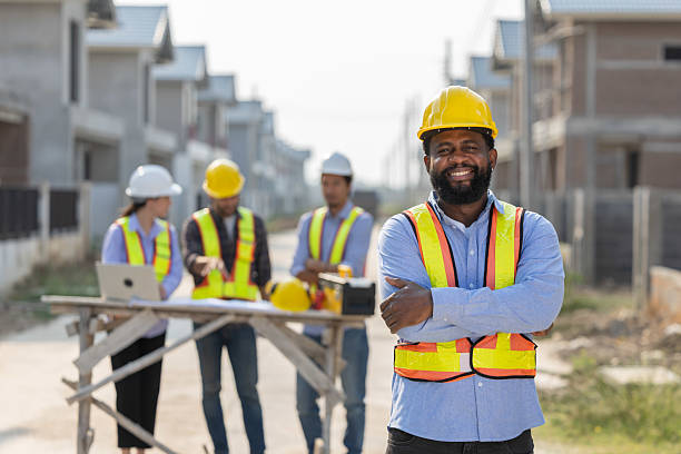 istock A group of construction workers engages in planning at a housing development with lead worker standing in front 2210416416