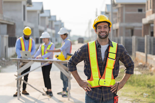 istock A group of construction workers engages in planning at a housing development with lead worker standing in front 2210416425