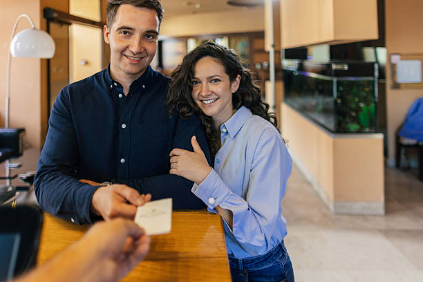 istock A young couple is checking in at the hotel reception. 2210419314
