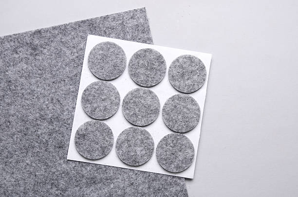 istock Felt protective circle pads for furniture on gray background 2210420228