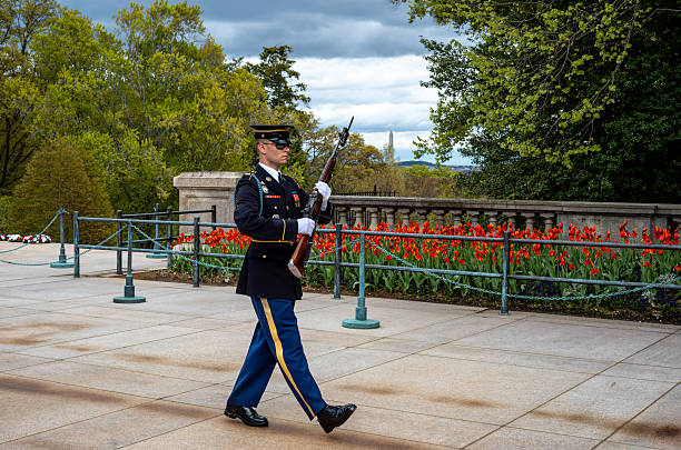 Soldier on guard duty wearing black leather gloves and assault rifle while patrolling