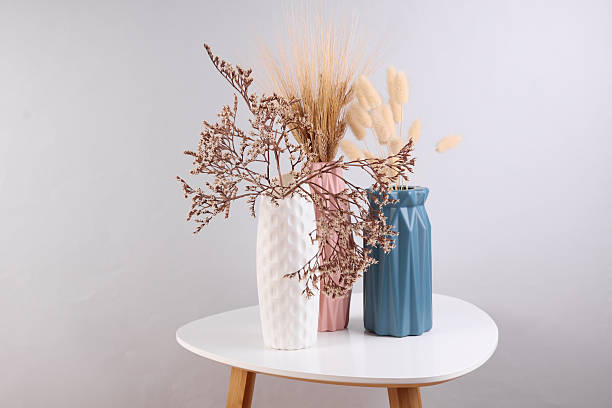 istock Vases with dried flowers on a coffee table 2210421620
