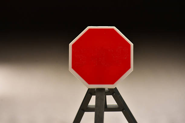 Red Hexagon ShapedTraffic Sign Isolated on Gray Background