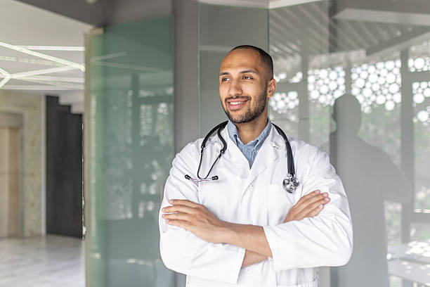 istock A young, friendly doctor stands confidently in a modern clinic, ready to provide excellent medical care. 2210423645