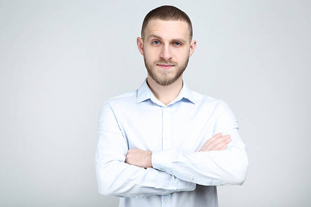 istock Portrait of young man on grey background 2210424654