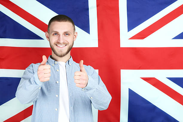 istock Young man on British flag background 2210424851