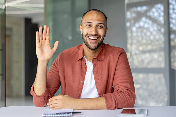 istock Web camera view, online video call, man looking at camera, waving hello, online business, educational remote conference. Businessman inside office at workplace 2210425881