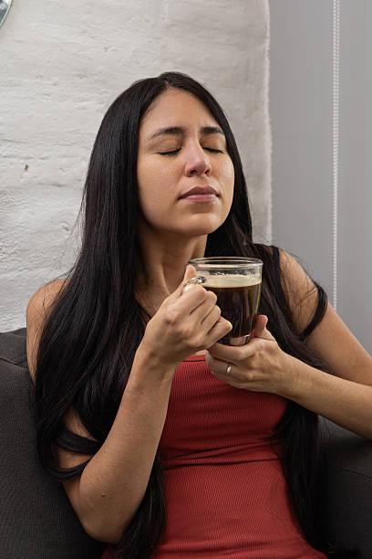 istock Woman Meditates Softly While Savoring Morning Coffee 2210430838