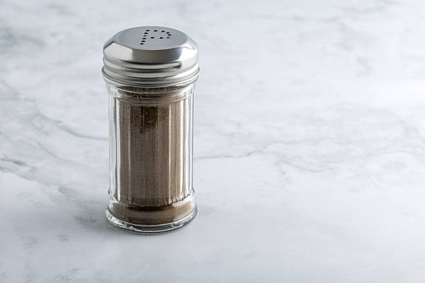 istock Pepper shaker with metal lid on marble surface 2210432416