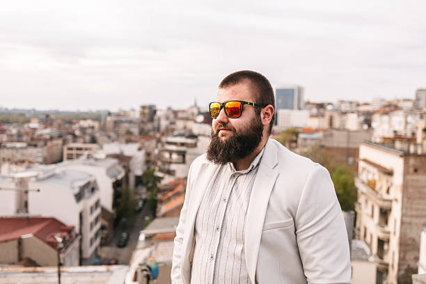 Young man businessman in white suit, standing casually . Copy space