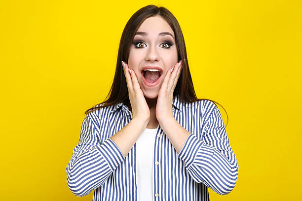 istock Beautiful young woman on yellow background 2210436435