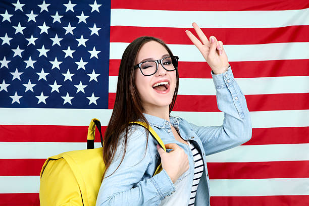 istock Young student with backpack on American flag background 2210438102