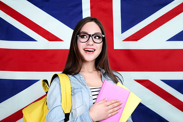 istock Young student with backpack and books on British flag background 2210438785