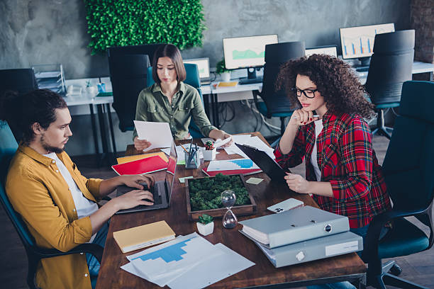 istock Diverse Group of Young Professionals Collaborating in Modern Office Workspace with Greenery and Technology 2210438900