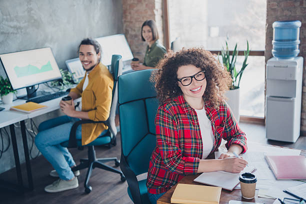 istock Friendly young coworkers collaborating in a modern office space with a comfortable atmosphere and natural daylight 2210438988