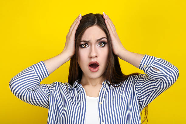 istock Beautiful young woman on yellow background 2210441286