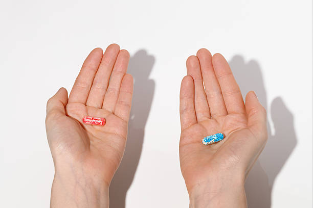 istock Conceptual image of red and blue pill in hands. Symbolic choice between two options. 2210441378