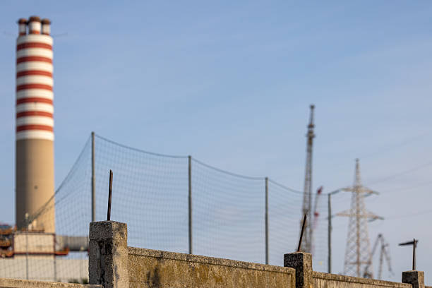 istock Industrial Chimney, Concrete Fence and Cranes in Construction Zone 2210442991