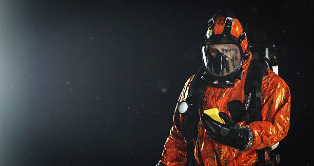 istock Man in Protective Suit and Respiratory Mask Against a Dark Background 2210443328
