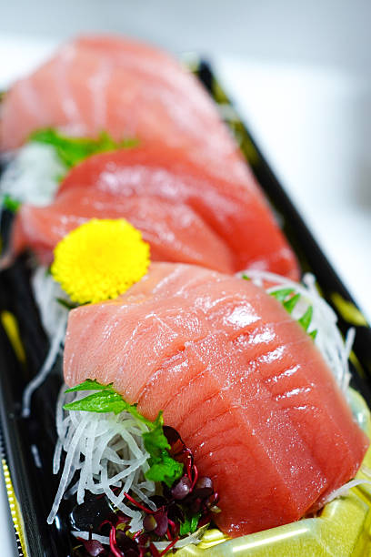 Assorted tuna sashimi in sushi containers for take-out