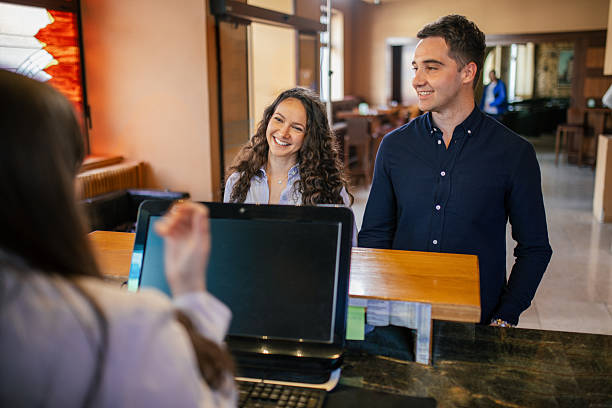 istock Young couple checking in a hotel reception desk 2210454331