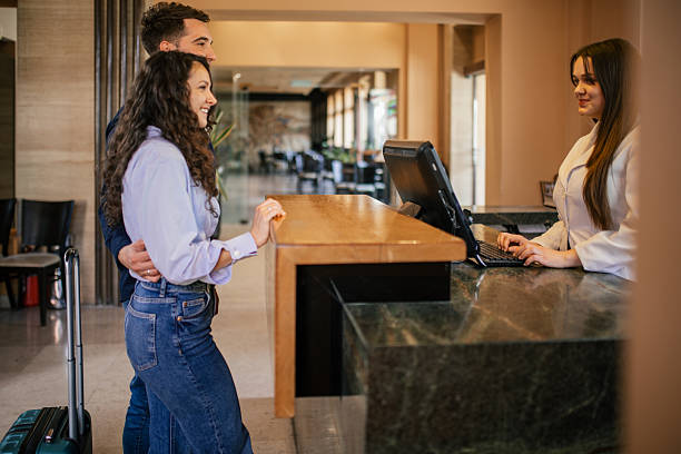 istock Young couple checking in a hotel reception desk 2210454795
