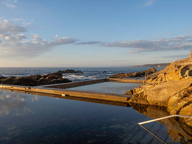 istock Morning light on ocean pool and rocky coastline 2210455411