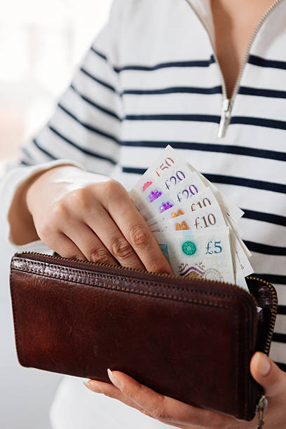 istock Woman hands holding money and wallet 2210456054