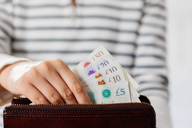istock Woman hands holding money and wallet 2210456078