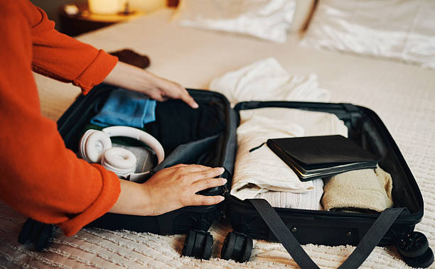 istock Woman Packing Suitcase for Travel on Bed 2210456882