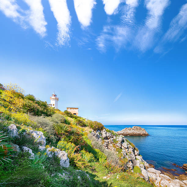 Splendid sunny day over Capo Zafferano Lighthouse. Popular travel destination of Mediterranean sea. Location: Santa Flavia, Province of Palermo, Sicily, Italy, Europe
