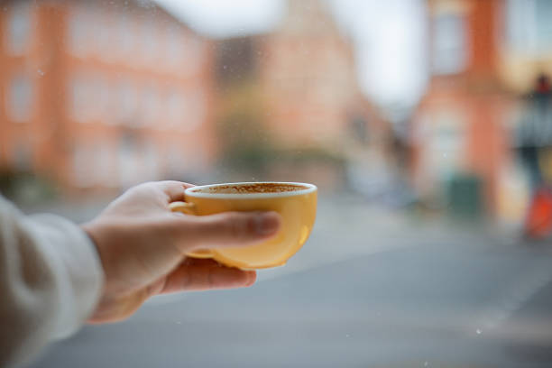 istock Person holding coffee cup on ledge 2210461667
