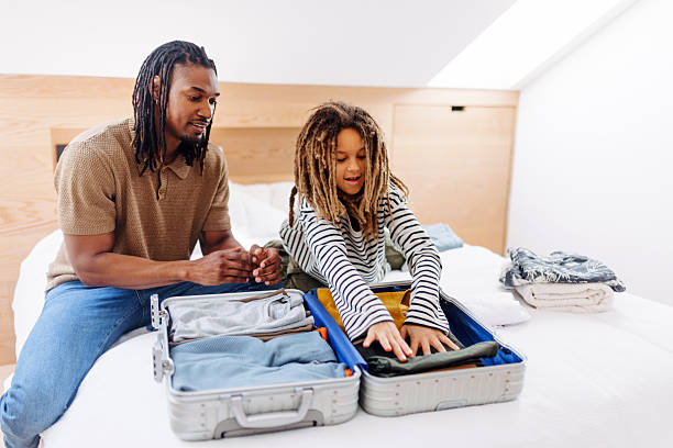 istock Father and Multiracial Son Packing for Vacation 2210463989