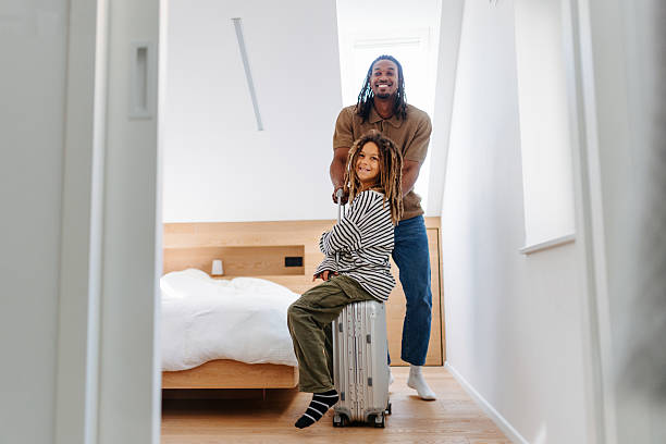 istock Father and Multiracial Son Packing for Vacation at Home 2210464000